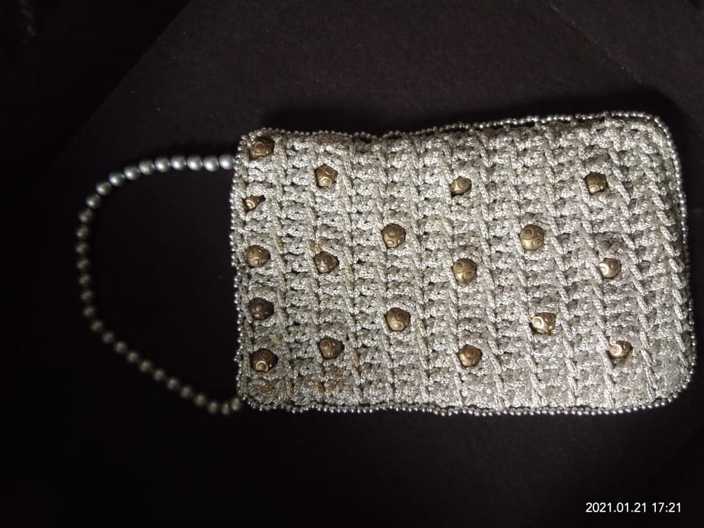 An elegant handmade crochet purse with beads and ivory thread